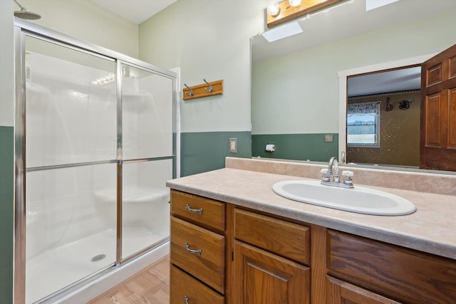 full bathroom with a shower stall and vanity