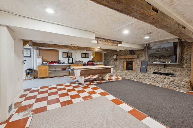 interior space featuring beam ceiling, a fireplace, recessed lighting, pool table, and tile patterned floors