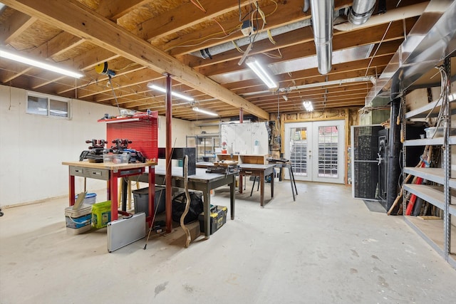 unfinished basement with french doors and a workshop area