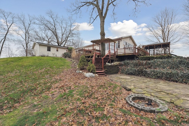 view of yard with stairway, a wooden deck, and a pergola