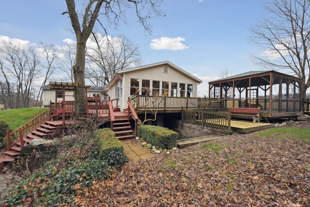 back of house with a deck and stairway