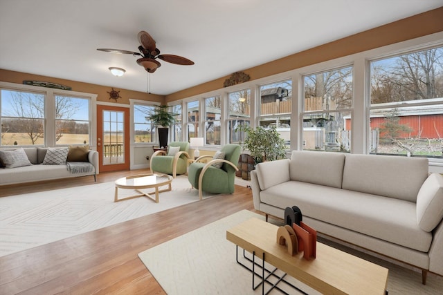 sunroom / solarium with a ceiling fan