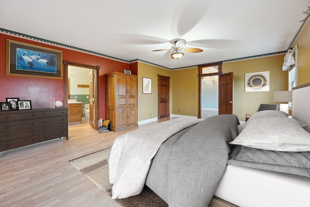 bedroom with ensuite bathroom, light wood-type flooring, a ceiling fan, and baseboards