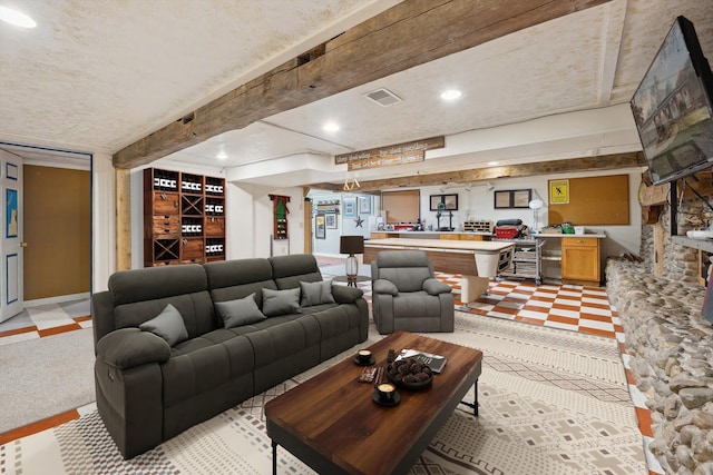 living room with light floors, beamed ceiling, visible vents, and recessed lighting