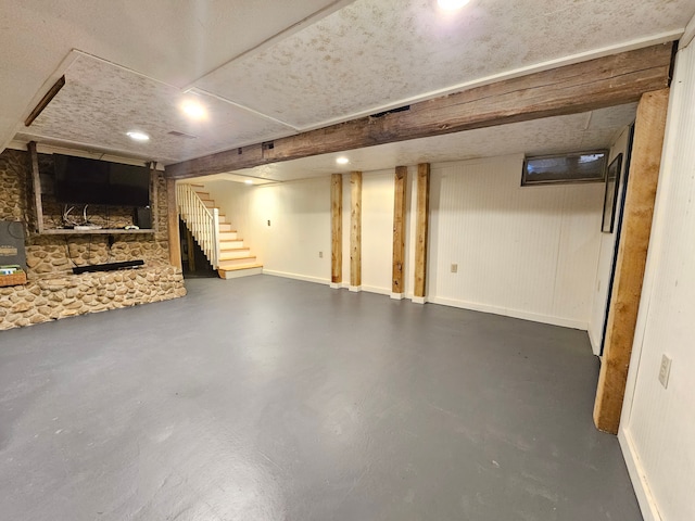 finished basement with stairway and baseboards