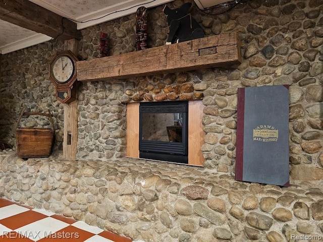 details with beamed ceiling and a glass covered fireplace