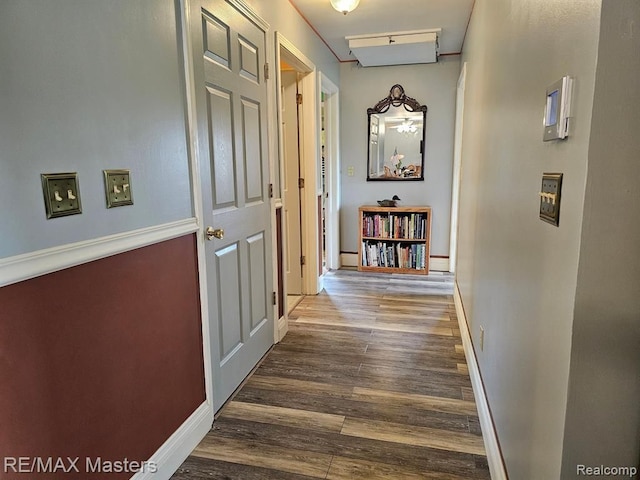 hallway with wood finished floors and baseboards