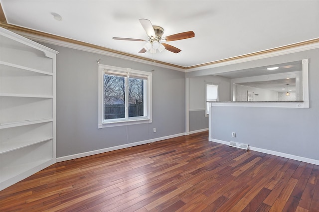 unfurnished room with ornamental molding, baseboards, and hardwood / wood-style flooring