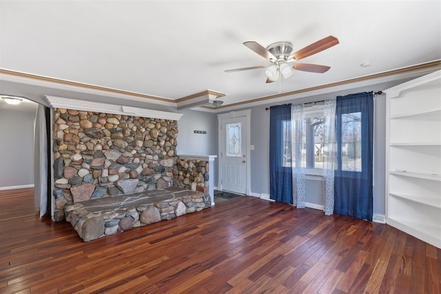 unfurnished living room featuring ornamental molding, ceiling fan, baseboards, and hardwood / wood-style flooring