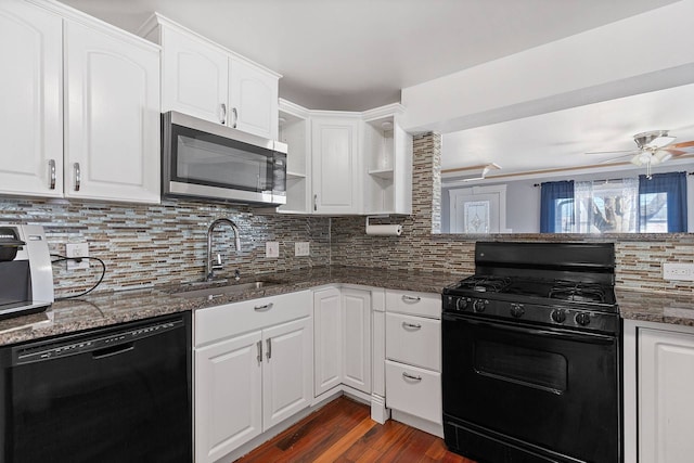 kitchen featuring black appliances, tasteful backsplash, open shelves, and a sink