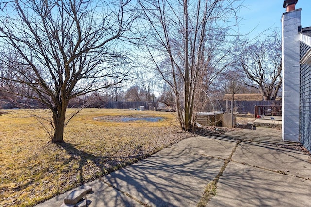 view of yard with fence and a patio