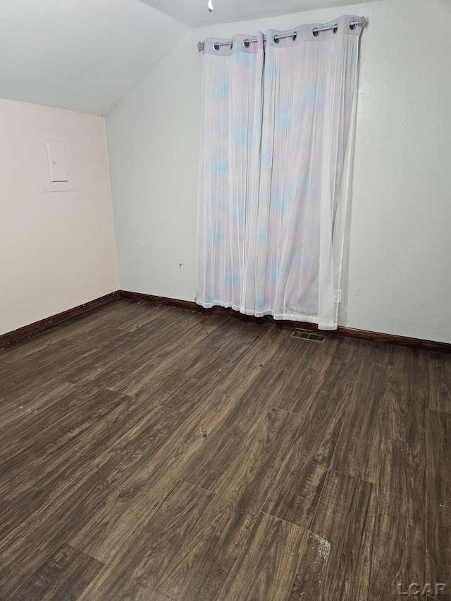 bonus room with dark wood-style floors, visible vents, vaulted ceiling, and baseboards