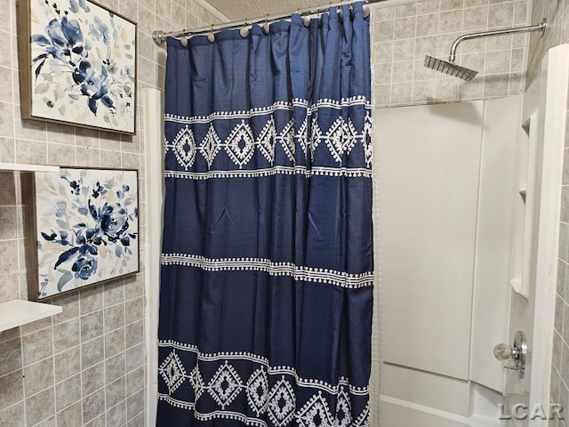 bathroom with tiled shower