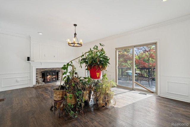 1869 Midchester Dr, West Bloomfield, MI 48324 - unfurnished living room with ornamental molding, a chandelier, a decorative wall, wood finished floors, and a fireplace