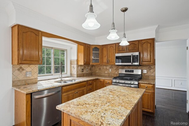 1869 Midchester Dr, West Bloomfield, MI 48324 - kitchen with stainless steel appliances, a sink, brown cabinets, a center island, and light stone counters