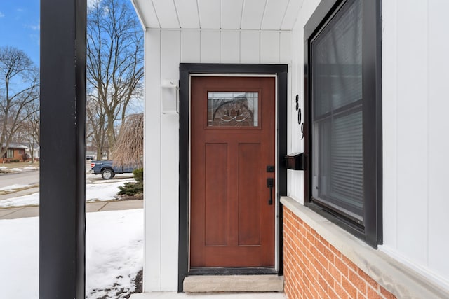 view of exterior entry with brick siding