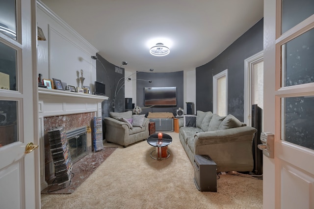 carpeted living area featuring a premium fireplace