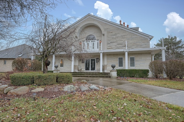 traditional-style home featuring stone siding