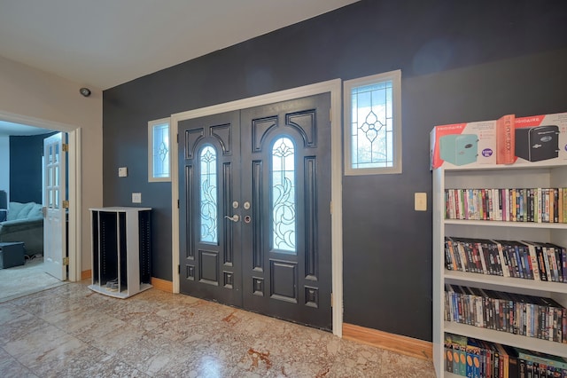 foyer entrance featuring baseboards