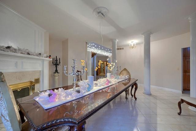 dining space featuring baseboards, visible vents, ornate columns, and tile patterned floors