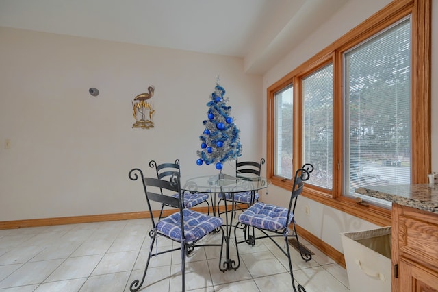 dining area featuring baseboards and light tile patterned floors