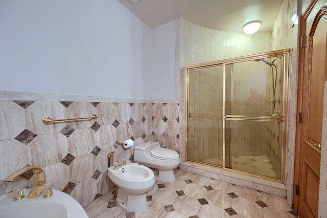 full bathroom featuring a stall shower, tile walls, a bidet, and a sink