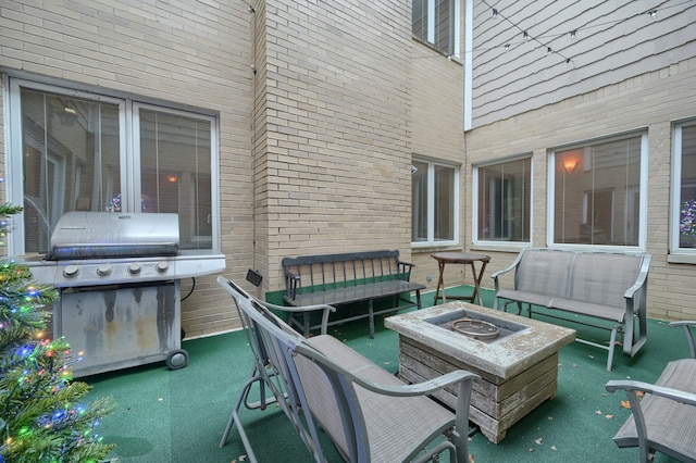 view of patio / terrace with an outdoor living space with a fire pit and area for grilling