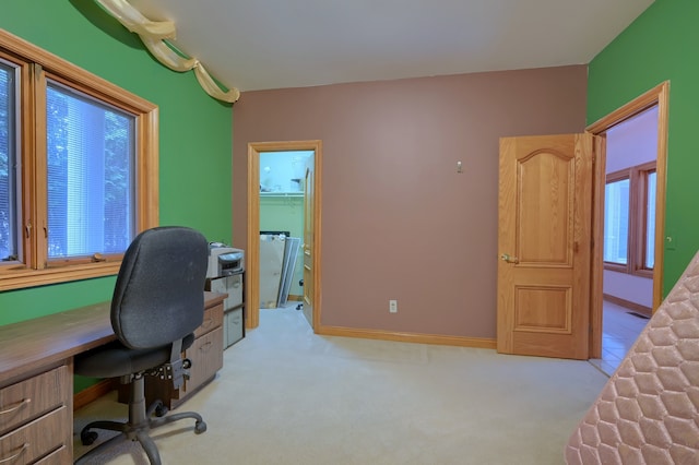 office with baseboards and light colored carpet