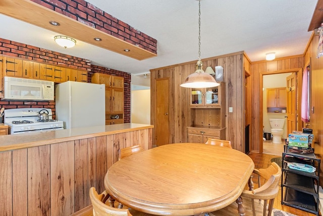 dining area with wooden walls