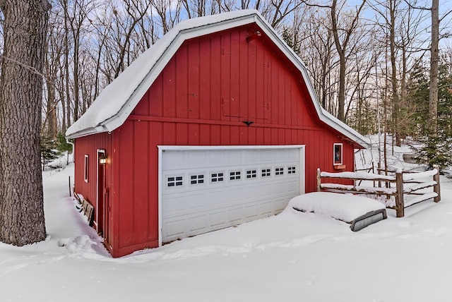 snow covered garage featuring a garage