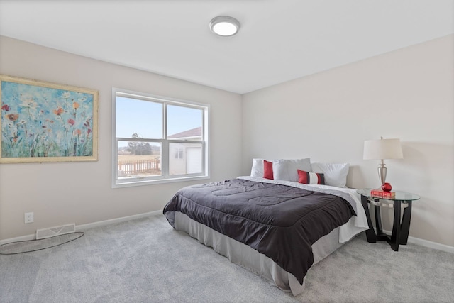 carpeted bedroom with visible vents and baseboards