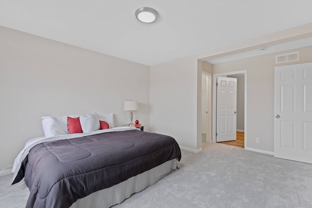 carpeted bedroom with baseboards and visible vents