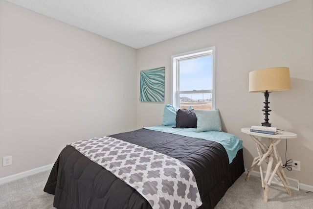 bedroom featuring carpet flooring, visible vents, and baseboards