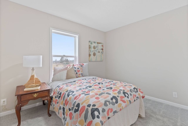 bedroom with baseboards and light colored carpet