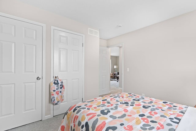 carpeted bedroom with visible vents