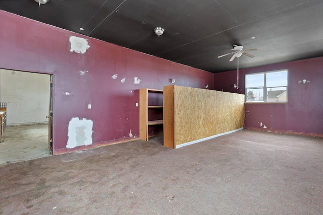 unfurnished room with carpet floors and a ceiling fan