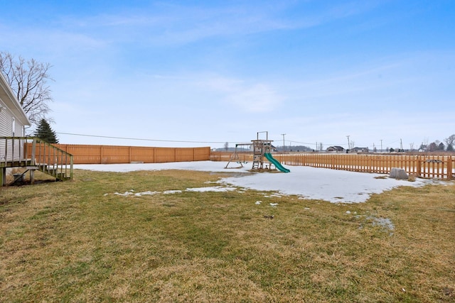 view of yard with a playground and fence