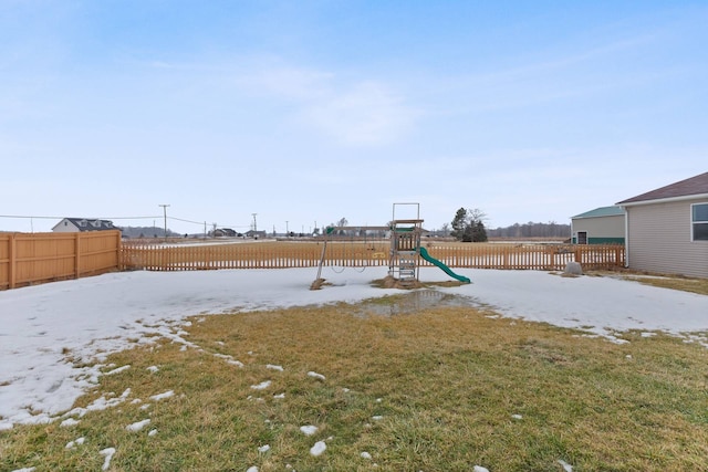 view of yard featuring a playground and a fenced backyard