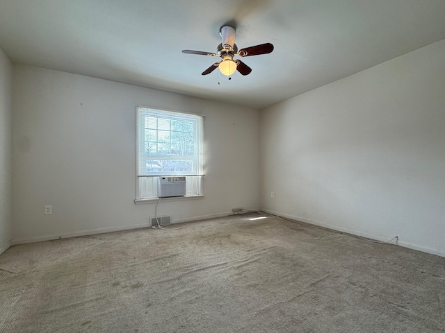 empty room with ceiling fan, visible vents, cooling unit, and light colored carpet