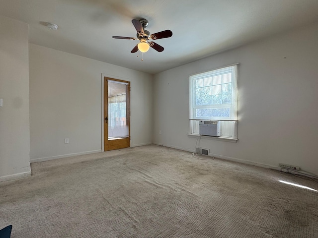 unfurnished room featuring light colored carpet, a healthy amount of sunlight, visible vents, and baseboards