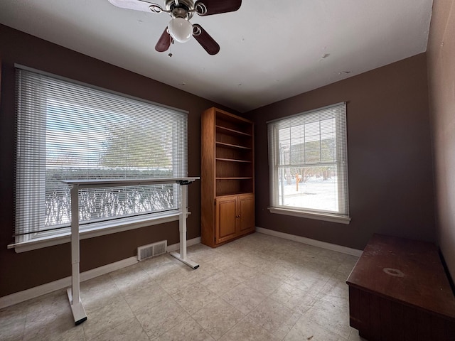 office featuring baseboards, visible vents, and ceiling fan