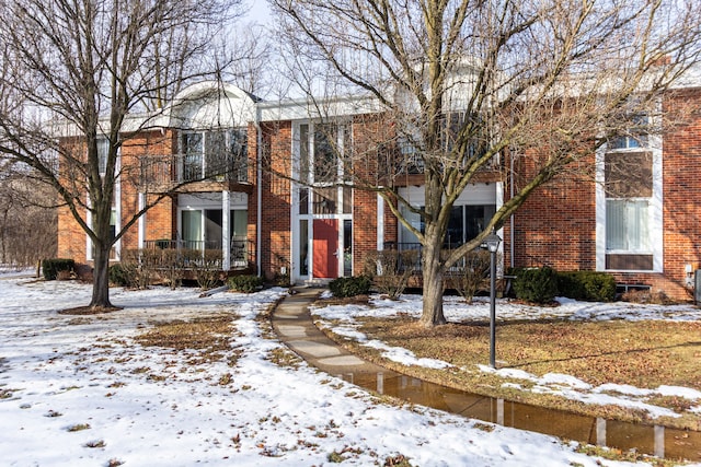 view of property with brick siding