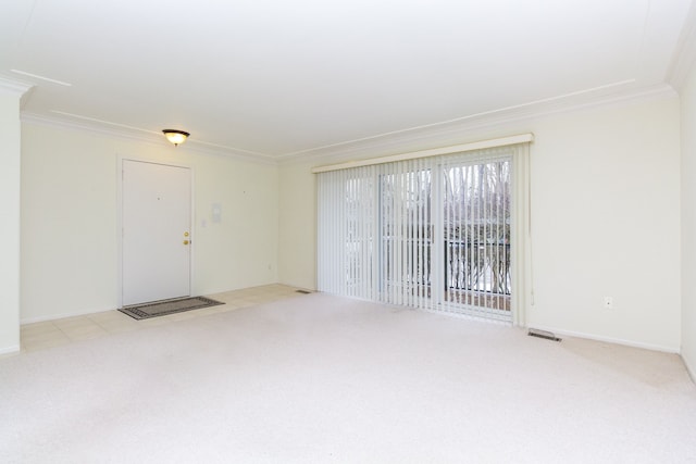 unfurnished room featuring light carpet, ornamental molding, visible vents, and baseboards