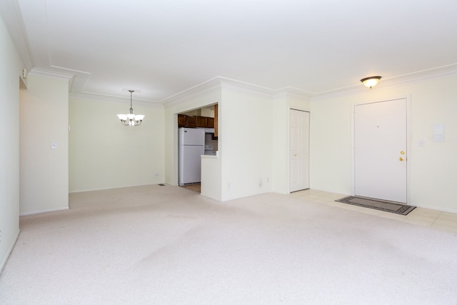 unfurnished living room featuring crown molding, an inviting chandelier, and light colored carpet