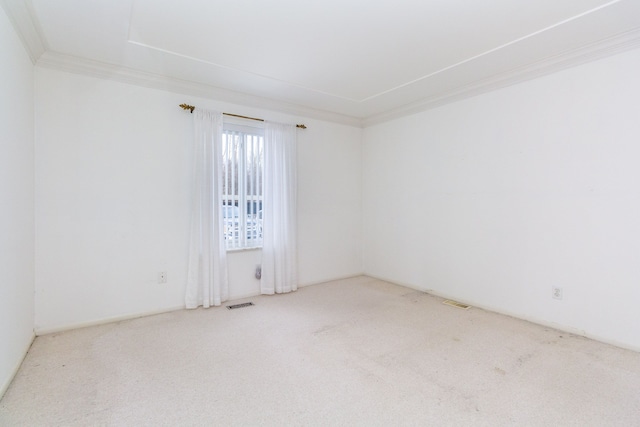 carpeted empty room with visible vents and crown molding