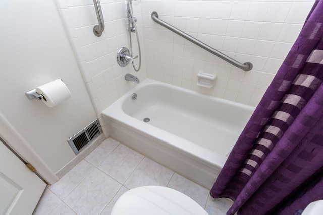 full bathroom with toilet, visible vents, baseboards, tile patterned floors, and shower / bath combo