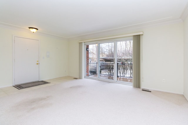 interior space with ornamental molding, light carpet, visible vents, and baseboards