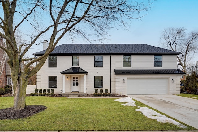 view of front facade with brick siding, concrete driveway, a chimney, an attached garage, and a front yard