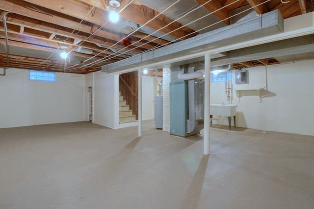 basement with water heater, stairs, and heating unit