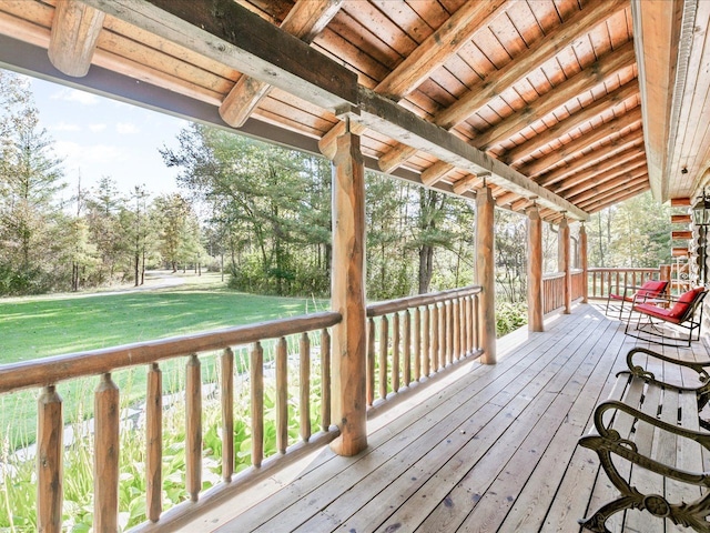 wooden deck with a lawn